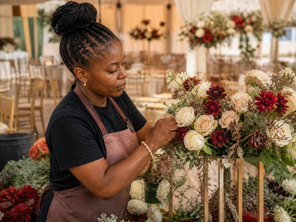 Nigerian florist preparing flowers for a wedding celebration