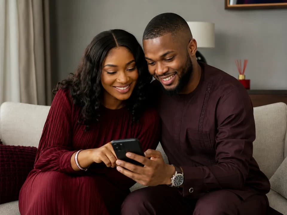 Nigerian couple sharing their wedding details on a phone